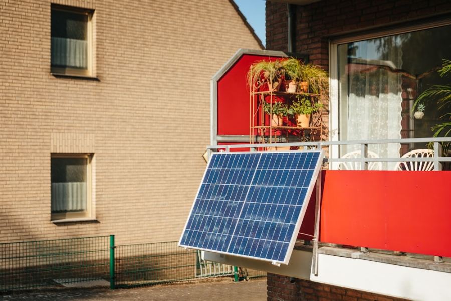 A solar panel on a balcony beside potted plants
