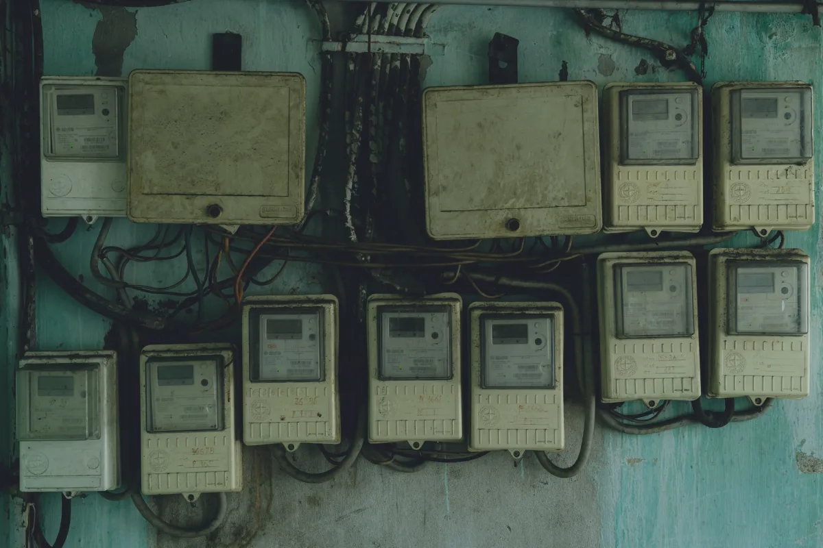 Aged and rusty electrical panels on an outdoor wall in Ho Chi Minh City, Vietnam.