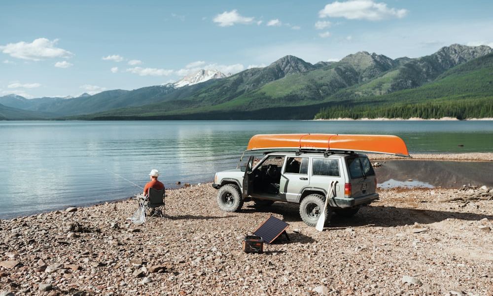 A folding solar panel and power station at a lakeside camp