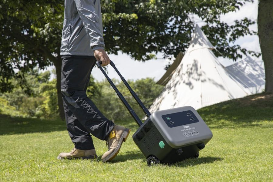 A portable power station being wheeled across a campsite